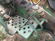 Tractors have independent rear wheel brakes to assist in turning. Note two pedals.