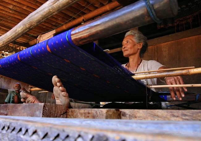 Weaving is the famous traditional home industry to produce woven fabrics called 'Tenun Ikat'.  Bena Village, Flores, East Nusa Tenggara, Indonesia